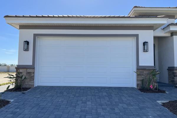 CHI Model 4250 Raised Long Panel Garage Door installed by ABS Garage Doors on a new home in Flagler Beach, Florida
