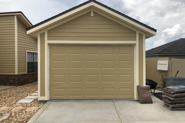New detached garage required the lower cost and simple look of a raised short panel garage door.