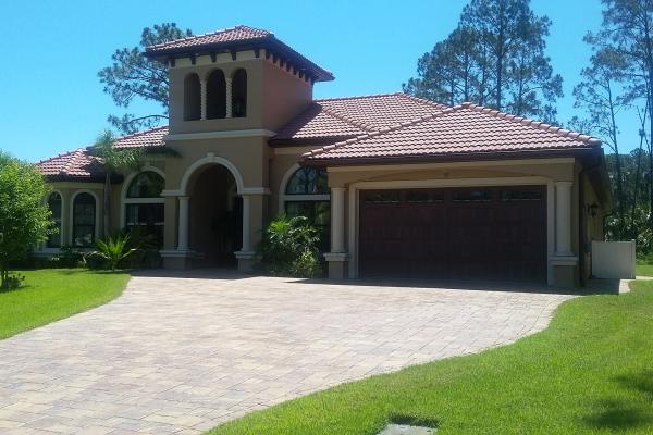 Accents woodtones garage door in a carriage house stamped style with Madison windows.