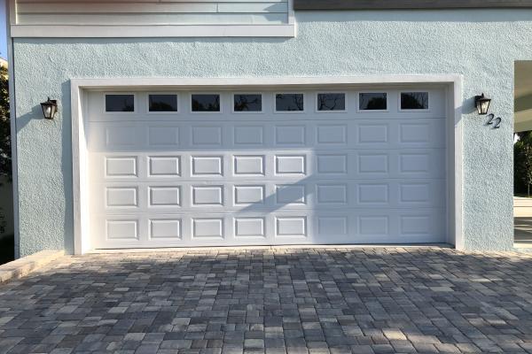 Oversized garage door in raised short panel with plain impact glass