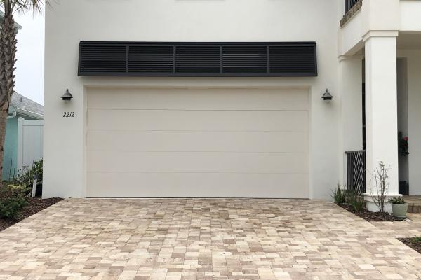 New construction home with the clean look of a CHI 2150 Flush Garage Door in custom color.