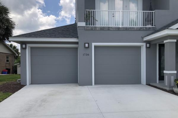 This project features the clean look of a flush panel garage door on a newly constructed home.