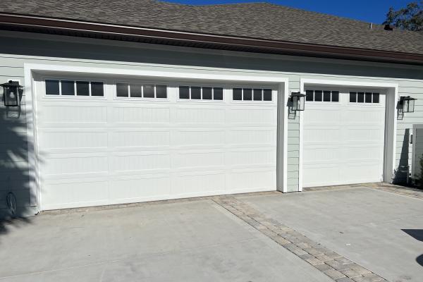 New construction home with CHI Stamped Carriage House Long Panel Garage Doors and Glass Top Sections, Madison Inserts and Seeded Glass. 