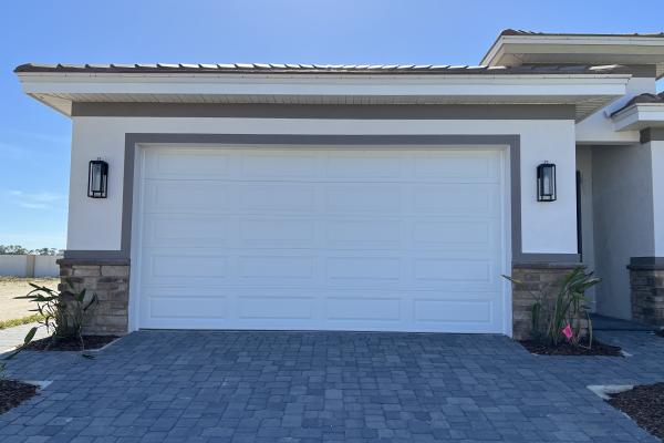 New construction home with CHI raised long panel garage door. 