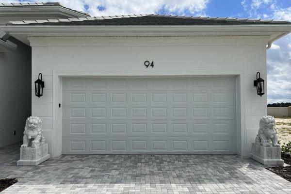 New construction home with raised short panel garage door. 