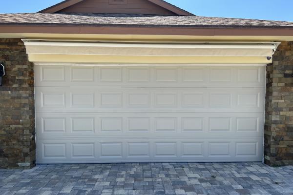 Remodeled home retrofitted with a raised short panel garage door almond color.