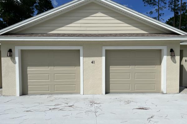 Recent installation with two raised long panel garage doors