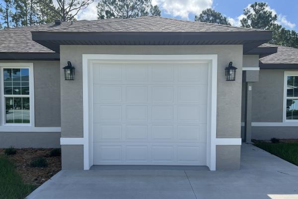 Recently build home with a raised short panel garage door.