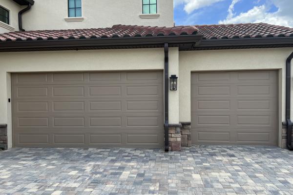 Recently construction home with two CHI model 4250 garage doors in custom color.
