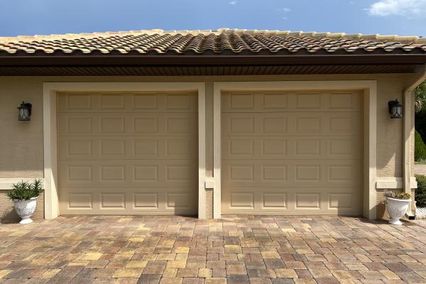 New construction home with raised short panel garage doors.