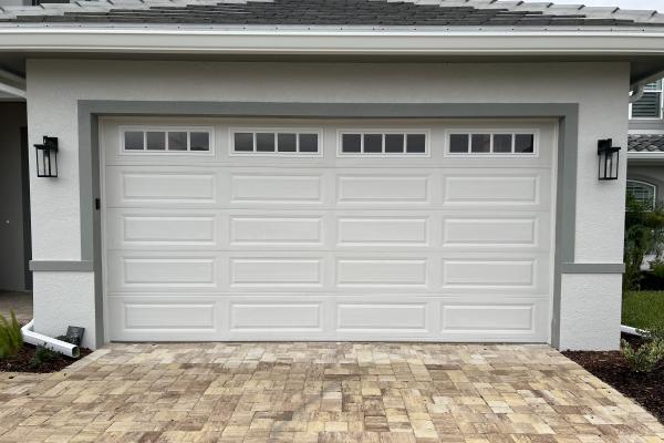 New construction home with Raised Long Panel Garage Door and Glass Top Section Madison Design. 