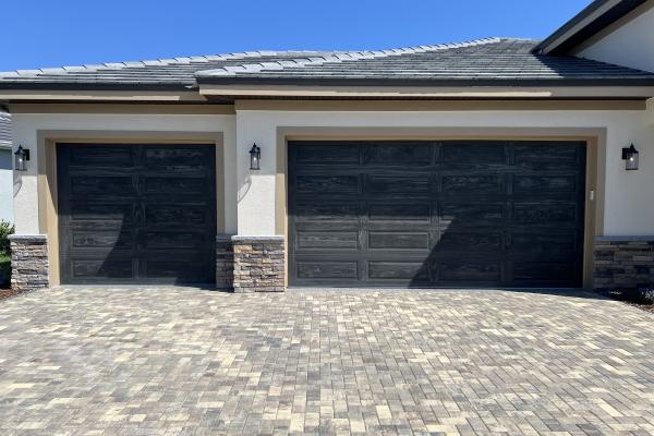 Raised Long Panel Garage Doors in Accents Carbon Oak Color.