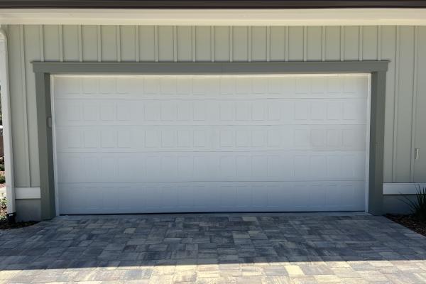 New build home with a Stamped Shaker garage door in custom color.
