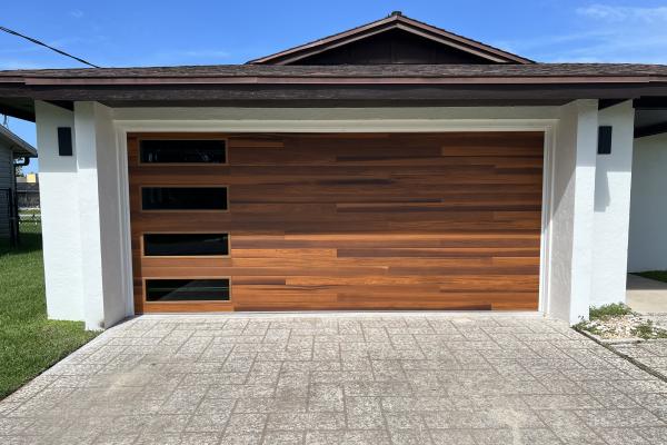 Home remodel utilizing a CHI Skyline Series Garage Door In Accents Cedar Color with Tinted Glass Windows. 