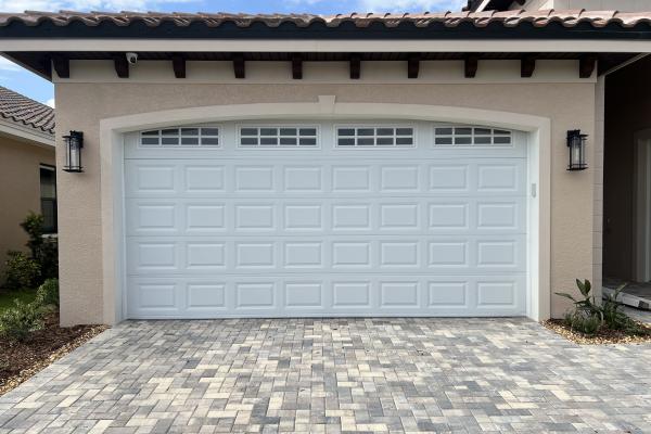 Recently constructed home with raised short panel garage door and arched stockton glass top section. 