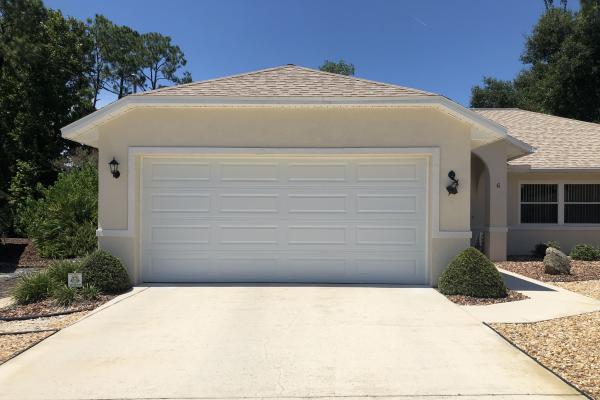Homeowner wanted to replace old garage door with one with a cleaner look. She chose the CHI model 4250 in white and is very happy with the result.
