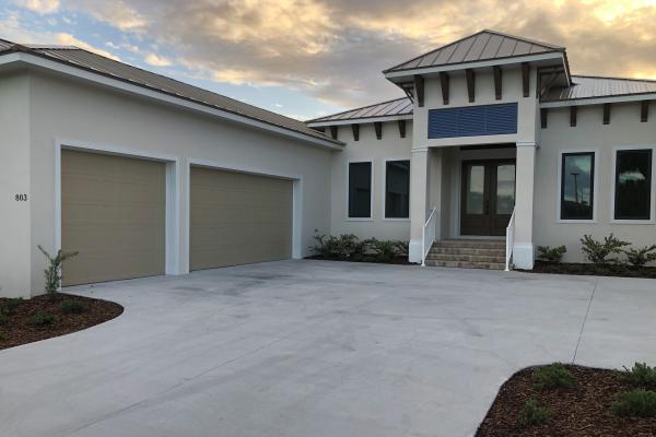 New construction project with garage doors featuring the C.H.I. Shaker Stamp design.