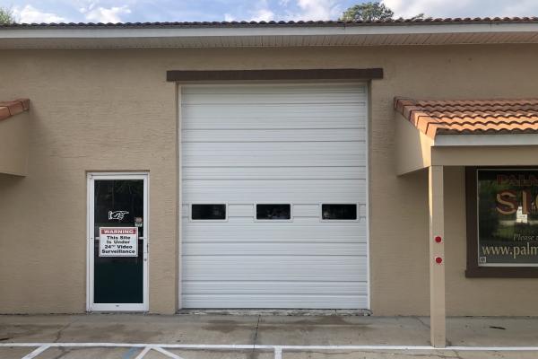 Customer wanted to be able to pull vehicles into their shop and still be able to see out into the parking lot. CHI ribbed steel commercial garage door with High Lift track and plain glass windows allowed them to do this.