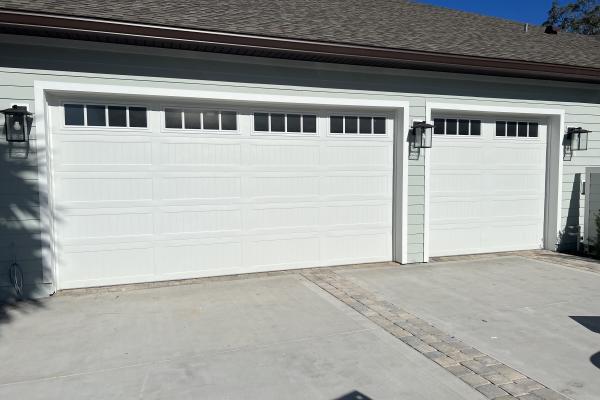 CHI Model 5951 Stamped Carriage House long panel doors with seeded glass and Madison inserts installed by ABS Garage Doors on a home located in the C Section of Palm Coast, Florida 
