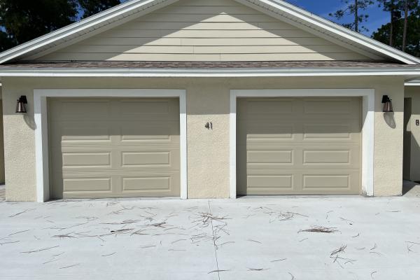 Two CHI model 4250 garage doors installed by ABS Garage Doors in Palm Coast, Florida