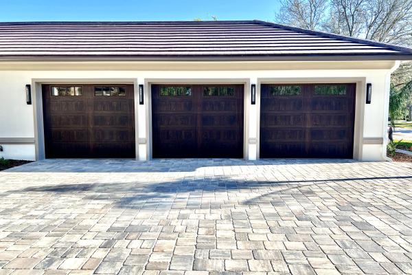 CHI model 2583 Stamped Shaker Accents with Madison Glass Top Section in Walnut color installed by ABS Garage Doors in Palm Coast, Florida