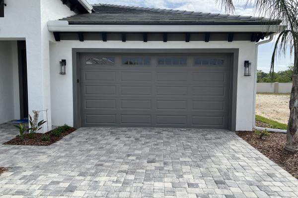 CHI 4250 Raised Long Panel Garage Door with Arched Madison Glass Top Section Installed by ABS Garage Doors Palm Coast, Florida